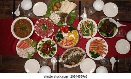 High Angle Shot With Zoom Out Traditional Food On Chinese New Year's Eve Dinner Table With Hotpot Seafood And Meat Dishes