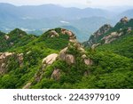 High angle and summer view of rocks and cliff of Munjangdae Peak at Songnisan National Park near Sangju-si, South Korea
