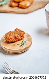 High Angle Of Tasty Chicken Nugget Served With Fresh Rosemary On Wooden Plate In Restaurant