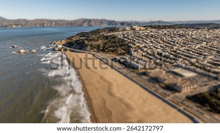 High angle, tilt-shift view of breaking waves at San Francisco's Ocean Beach.