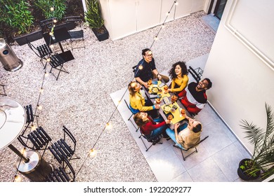 High Angle Top View Of Happy Friends Drinking Cocktails And Having Fun At Restaurant Garden Party - Food And Beverage Life Style Concept With Young People Together At Home Patio - Dark Warm Filter