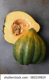 High Angle View Of An Acorn Squash Cut In Half On A Metal Baking Sheet.