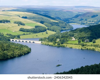 High angle view of arched bridge viaduct over Ladybower Reservoir in Peak District National Park in United Kingdom on a beautiful summer day.