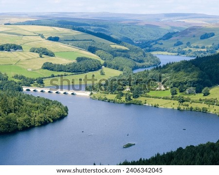 High angle view of arched bridge viaduct over Ladybower Reservoir in Peak District National Park in United Kingdom on a beautiful summer day.