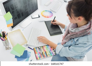 High angle view of an artist drawing something on graphic tablet at the office - Shutterstock ID 168161747