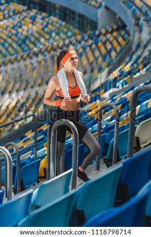 high angle view of attractive young woman with towel at sports stadium