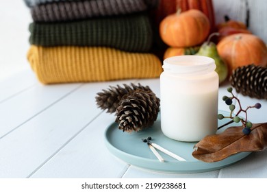 High Angle View Autumn Composition With Sweaters And Candles, White Candle Mockup Design