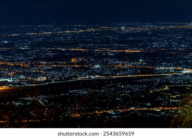 High angle view background from the mountain, showing the lights of apartment buildings, houses, car lights and street lights, the advancement of technology and electricity lighting at night. - Powered by Shutterstock