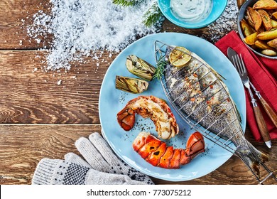 High angle view of barbecued fish on plate with crayfish against table