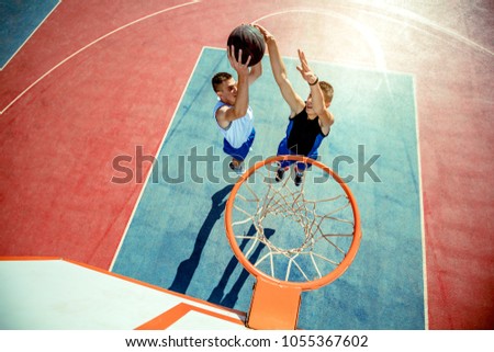 High angle view of basketball player dunking basketball in hoop