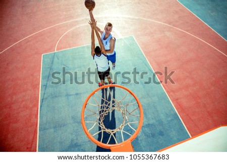 High angle view of basketball player dunking basketball in hoop