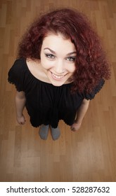 High Angle View Of Beautiful Young Woman Looking Up At Camera