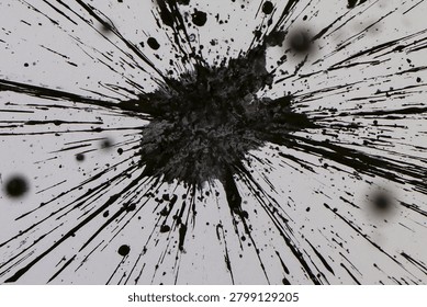 High angle view of black ink splash explosion with radiating lines