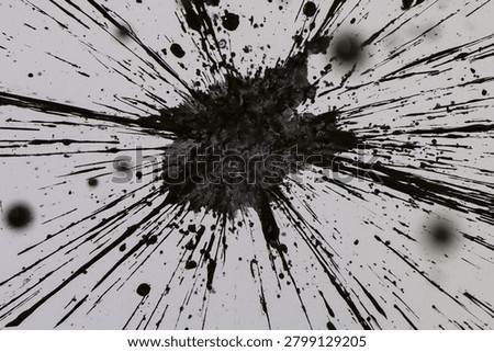 High angle view of black ink splash explosion with radiating lines