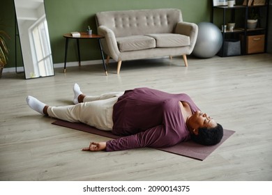 High Angle View At Black Senior Woman Laying On Yoga Mat And Relaxing While Enjoying Yoga At Home