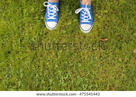 Similar – Person standing on a path with a green leaf nearby