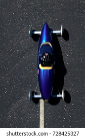 High Angle View Of Blue Soap Box Car Taking Part In Soap Box Derby