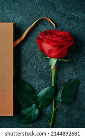 High Angle View Of A Book With The Catalan Flag And A Red Rose For Sant Jordi, The Catalan Name For Saint George Day, When It Is Tradition To Give Red Roses And Books In Catalonia, Spain