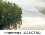 High angle view of boundary waters lake and trees in morning fog in northern Minnesota during fall