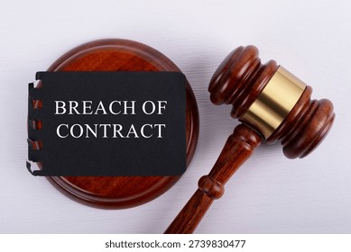 High angle view of Breach of contract word and gavel set