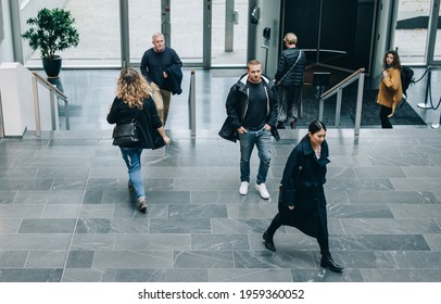 High Angle View Of Business People In A Lobby. Business People Walking Through A Office Hallway.