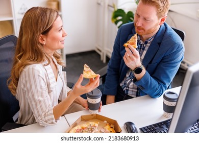 High angle view of business people taking a lunch break at the office, eating pizza and drinking coffee - Powered by Shutterstock