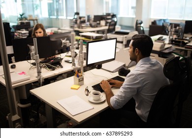 High Angle View Of Businessman And Businesswoman Working In Office