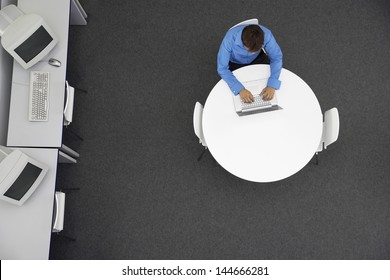 High Angle View Of Businessman Using Laptop In Computer Room