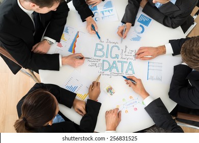 High Angle View Of Businesspeople Planning Bigdata