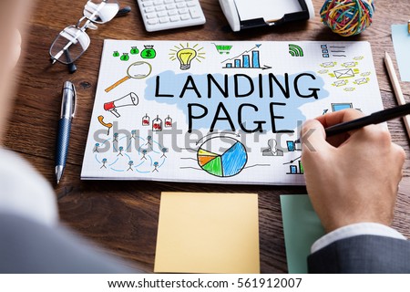 High Angle View Of Businessperson Drawing Landing Page Concept At Wooden Desk 