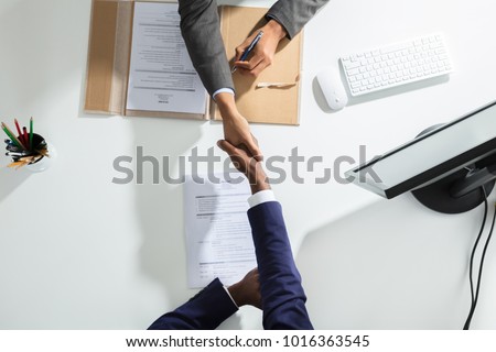 High Angle View Of Businessperson Shaking Hand With Candidate Over White Desk Сток-фото © 