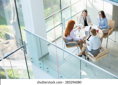 High Angle View Of Businesswomen Discussing At Table In Office