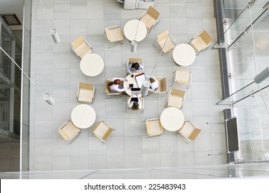 High Angle View Of Businesswomen Working In Office Canteen