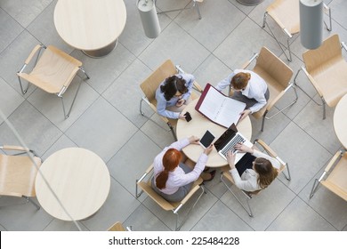 High Angle View Of Businesswomen Working In Office Canteen