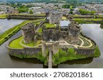 High angle view of Caerphilly Castle ruins, showing its concentric design and moat