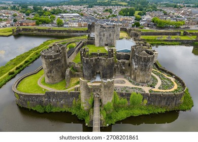 High angle view of Caerphilly Castle ruins, showing its concentric design and moat