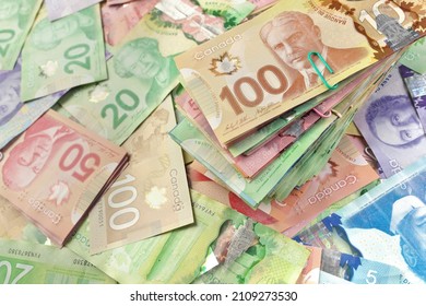 High Angle View of Canadian Banknotes of Different Values with a Large Stack of Bills on Top
