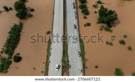 High angle view of car stuck on the bridge after road flooded during typhoon Yagi has swept Chiang Rai province of Thailand.