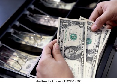 High angle view of cashier searching for change in cash