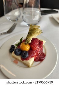 High Angle View Of Cheese Cake Top With Raspberry Jam And Physalis Angulata L (Morel Berry)