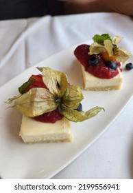 High Angle View Of Cheese Cake Top With Raspberry Jam And Physalis Angulata L (Morel Berry)