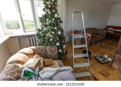 High Angle View Of Christmas Tree With Messy Boxes On Floor Of New Apartments.