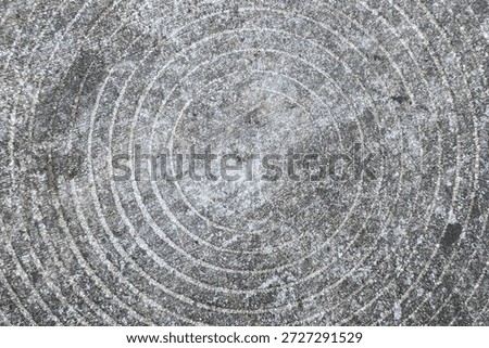 High angle view of circular brushed gray concrete stone texture.