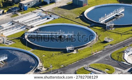 High angle view of circular clarifiers and industrial infrastructure at a modern water treatment facility.