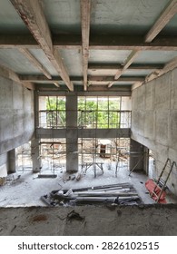 High angle view of concrete grid beam ceiling structure at commercial building construction project with steel scaffolding below.