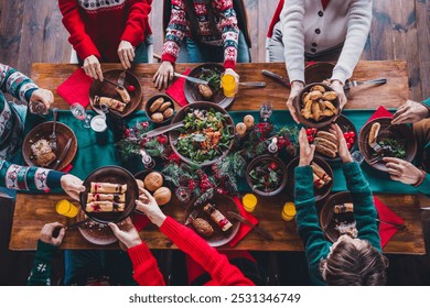 High angle view cropped photo of group family members eat food table gather celebrate christmas apartment indoors - Powered by Shutterstock