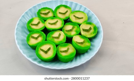 High angle view of delicious green pandan nona manis cakes on a plate