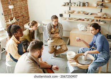 High angle view at diverse group of people at pottery workshop in cozy studio, copy space - Powered by Shutterstock