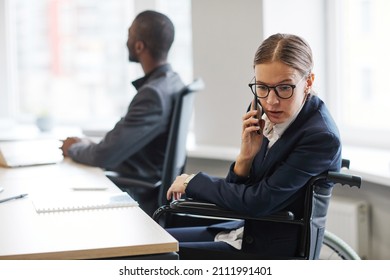 High Angle View At Diverse Group Of People At Business Meeting In Office With Young Woman Using Wheelchair