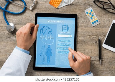 High Angle View Of Doctor Hand Checking Medical Report On Digital Tablet. Doctor Checking Patient Health History. Top View Of Male Doctor Hands Using Tablet At Clinic To Review Mediacal Report.